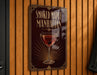 A sign for "Smoked Maple Manhattan" is displayed on a wooden wall.