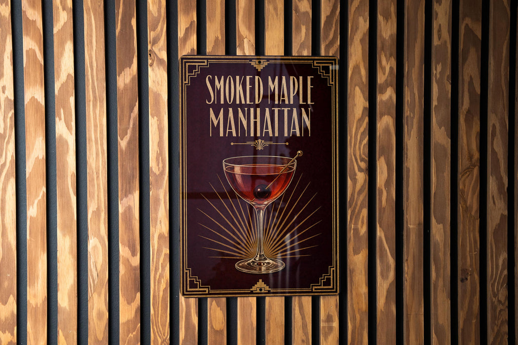 A poster for "Smoked Maple Manhattan" cocktail is displayed on a wooden wall.