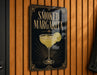 A sign for "Smoked Margarita" is displayed on a wooden wall.