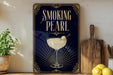 a poster with a stylized design, including a glass of white liquid and a lemon, along with the text "SMOKING PEARL" and decorative elements.