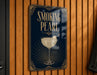 A sign that reads "Smoking Pearl" is hanging on a wooden wall.