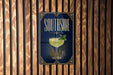 A poster with the word "SOUTHSIDE" and an illustration of a cocktail is displayed on a wooden wall.