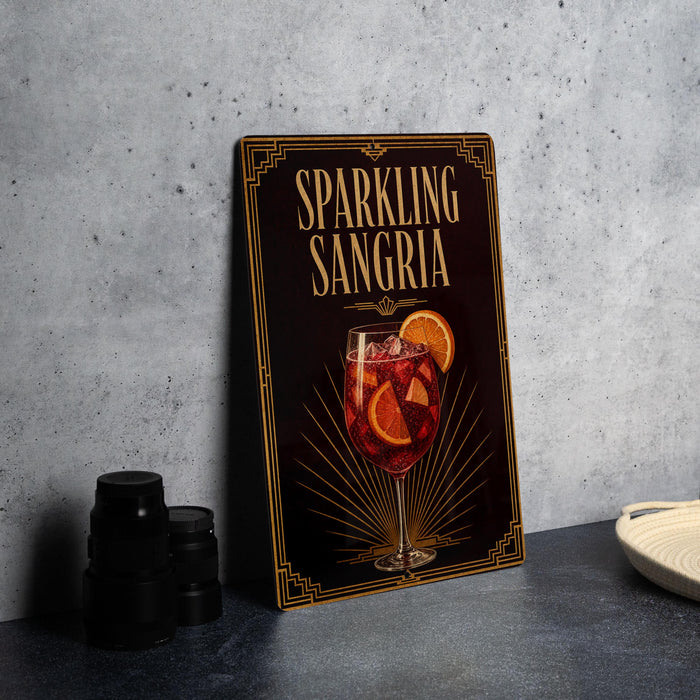 A framed poster advertising "Sparkling Sangria" is displayed on a gray wall, featuring an illustration of a glass filled with a red drink and slices of orange.