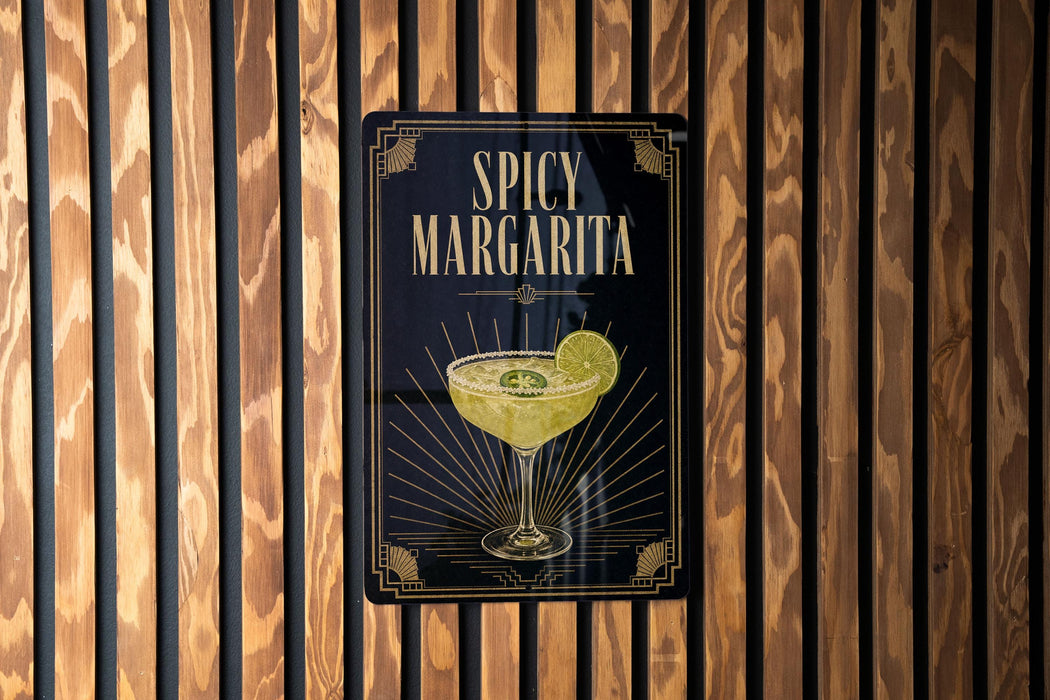 A sign for a spicy margarita cocktail is displayed on a wooden wall.