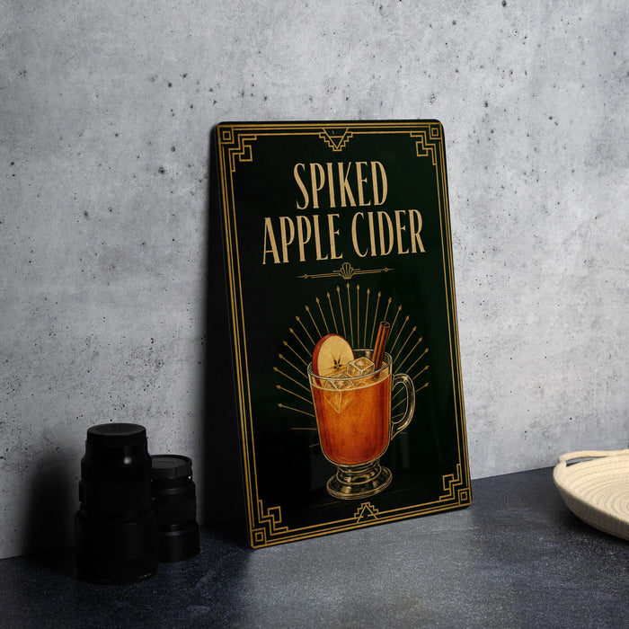 a framed illustration of a spiked apple cider on a black background with a decorative border.