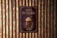 A sign for "Spiked Hot Chocolate" is displayed on a wooden wall.