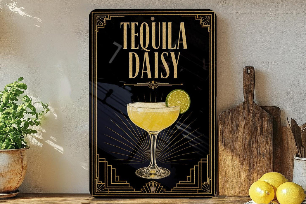 A decorative sign for "Tequila Daisy" cocktail, featuring a glass of tequila with a lime slice, placed on a wooden surface next to a cutting board and some lemons.