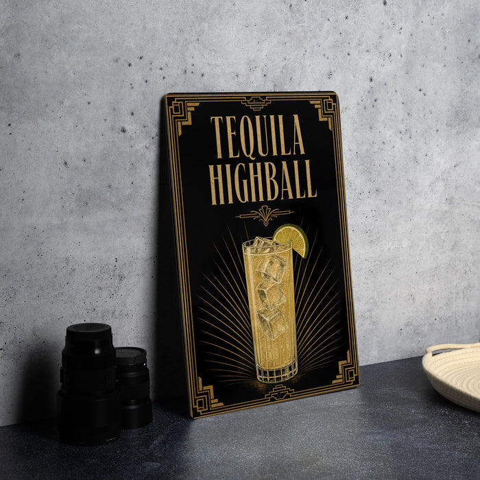 A framed poster advertising "Tequila Highball" on a wall, featuring an illustration of a tequila highball cocktail with a lemon slice.