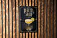 A sign for "Tequila Sour" is displayed on a wooden wall.