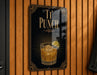 A sign that reads "T'PUNCH" with an illustration of a cocktail glass and a lime slice on a wooden wall.