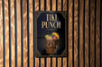 A sign for "Tiki Punch" is displayed on a wooden wall.