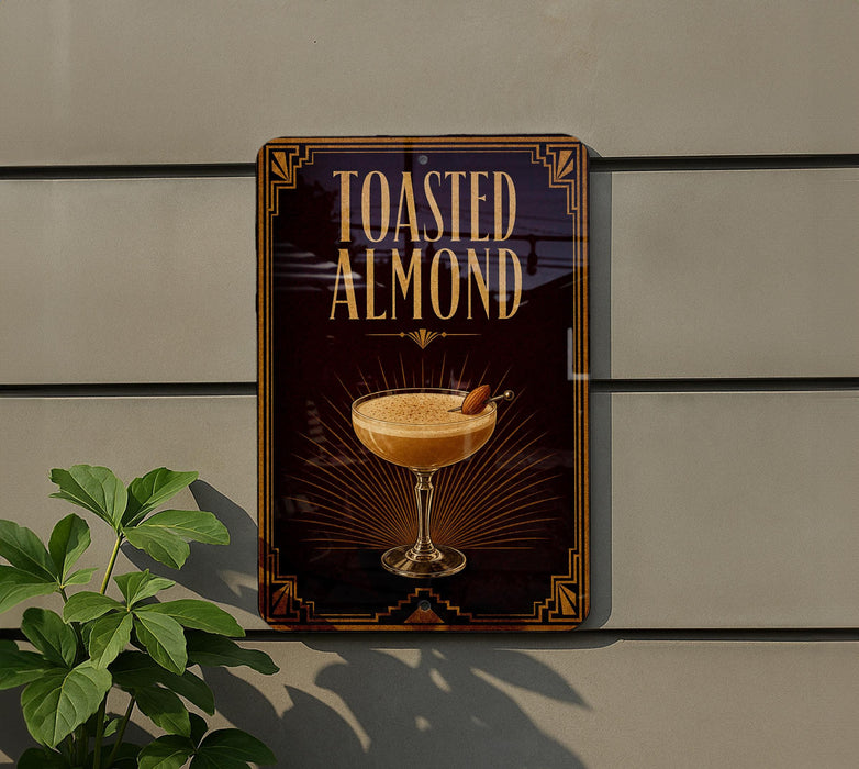 A sign for "Toasted Almond" cocktail is displayed on a wall, featuring an illustration of a cocktail glass with a toasted almond garnish.