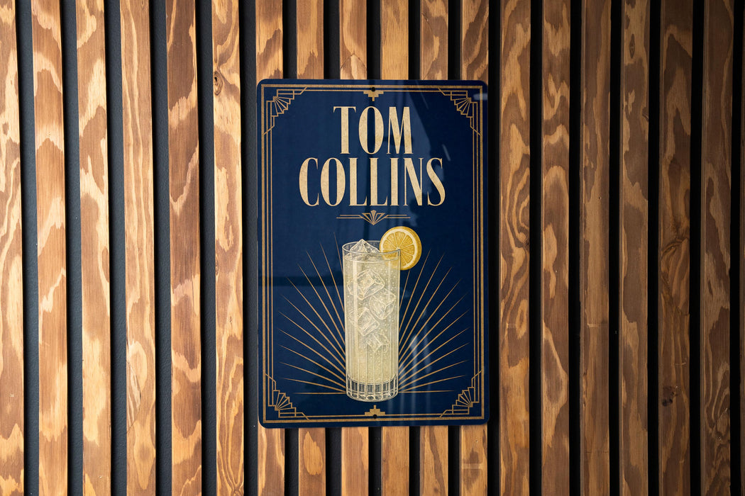 A sign for "Tom Collins" cocktail is displayed on a wooden wall.
