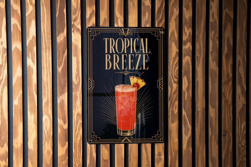 A sign for a tropical breeze cocktail is displayed on a wooden wall.
