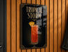 A sign for a tropical storm cocktail is hanging on a wooden wall.