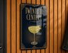 A sign that reads "Twentieth Century" with an illustration of a cocktail glass on a dark background.