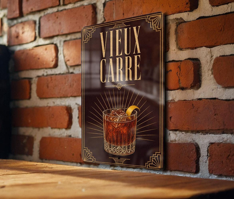 a poster with a glass of amber-colored liquid and a lemon slice, mounted on a brick wall.