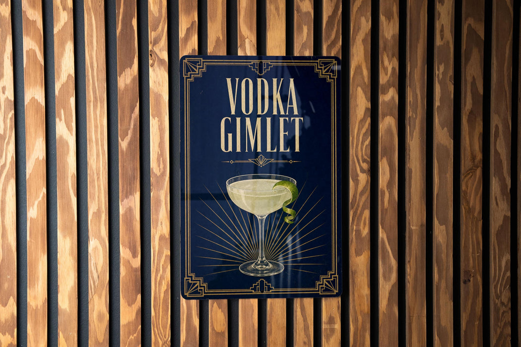 A sign for vodka gimlet is displayed on a wooden wall.