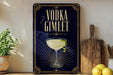 a decorative sign with the text "VODKA GIMLET" and an illustration of a martini glass with a lime twist.