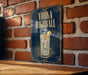 A sign with the text "VODKA HIGHBALL" and an illustration of a cocktail glass with ice and a lemon slice.