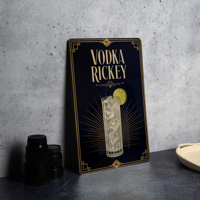 a black and gold sign with the text "VODKA RICKEY" and an illustration of a cocktail glass with a lemon slice.