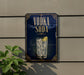 A sign for vodka soda is displayed on a wall, featuring a glass of vodka soda with a lime slice.