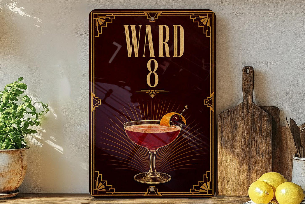 A decorative sign with the number "8" and a cocktail image, placed on a wooden surface next to a wooden cutting board and a potted plant.