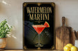 A framed advertisement for a "Watermelon Martini" cocktail, featuring a glass of the drink with a slice of watermelon on the rim.