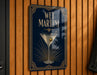 A sign for "Wet Martini" is displayed on a wooden wall, featuring an illustration of a martini glass with a green olive.