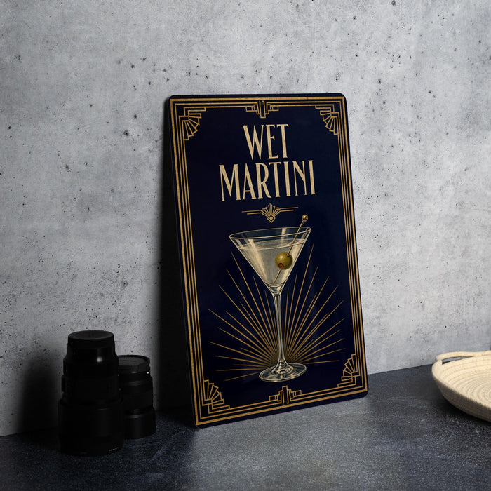 A framed image of a martini glass with a green olive on a dark background, accompanied by the text "WET MARTINI" in a decorative font.