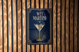 A sign for "Wet Martini" is displayed on a wooden wall.