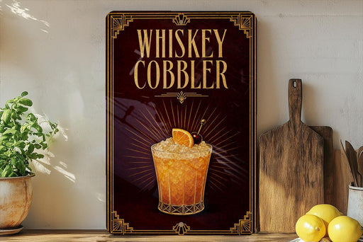 A framed advertisement for a whiskey cobbler cocktail, featuring an illustration of a glass filled with the cocktail and garnished with an orange slice.