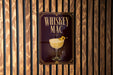 A sign for "Whiskey Mac" is displayed on a wooden wall.