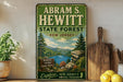 A vintage-style sign for Abraham S. Hewitt State Forest in New Jersey, featuring a scenic landscape with pine trees, a lake, and mountains.
