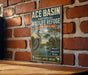 A vintage-style sign for Ace Basin National Wildlife Refuge in South Carolina, featuring a large heron and a tropical landscape.