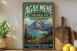 A vintage-style sign for Agay Mene Territorial Park Yukon, featuring a scenic mountain landscape with a river and pine trees.