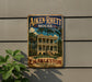 A vintage-style metal sign for the Aiken-Rhetcht House in Charleston, South Carolina, featuring a large illustration of the historic building surrounded by palm trees.
