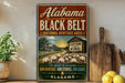 A vintage-style sign for Alabama's Black Belt National Heritage Area, featuring a rural landscape with a cotton plantation and a wooden barn.