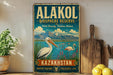 A vintage-style metal sign advertising the Alakol Biosphere Reserve in Kazakhstan, featuring a scenic illustration of a pelican and a lake surrounded by mountains.