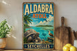 A vintage-style poster of Aldabra, Seychelles, featuring a large tortoise, palm trees, and a seascape with a bird and fish.