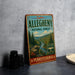 a vintage-style metal sign for the Allegheny National Forest in Pennsylvania, with a scenic illustration of a forest and a river.
