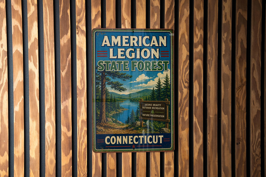 A vintage metal sign for the American Legion State Forest in Connecticut, featuring a scenic landscape with pine trees and a lake.