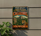 a vintage metal sign with a jungle scene and a jaguar, mounted on a wall.