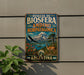 A vintage metal sign with the text "RESERVA DE BIOSFERA ANDINO NORPATAGONICA ARGENTINA" and an illustration of a mountain, a llama, and a bird.