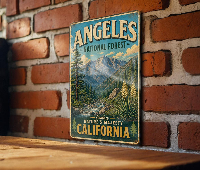 A vintage metal sign with the text "ANGELES NATIONAL FOREST" and "EXPLORE NATURE'S MAJESTY CALIFORNIA" is displayed on a brick wall.