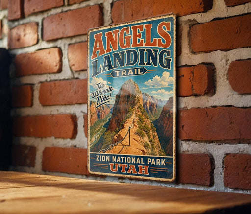 A vintage-style metal sign for the Angels Landing Trail in Zion National Park, Utah, featuring a mountain landscape with a winding trail.
