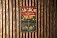 A vintage-style metal sign with the text "ANGKOR CAMBODIA" and an illustration of the Angkor Wat temple complex in Cambodia.