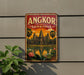 A vintage-style sign displaying the name "ANGKOR CAMDENIA" and an illustration of the Angkor Wat temple complex in Cambodia.