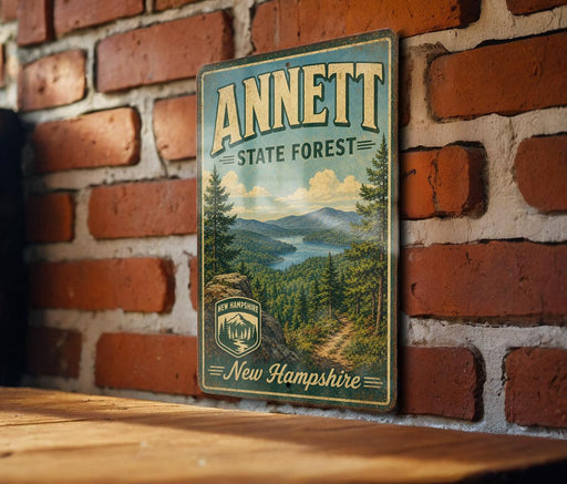 A vintage metal sign for the state forest in New Hampshire, featuring a scenic landscape with mountains, forests, and a river.