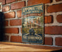 A vintage-style metal sign for the Appomattox Court House, a National Historical Park in Virginia, featuring an illustration of a house with a wagon and a banner that reads "The Site of the Surrender".
